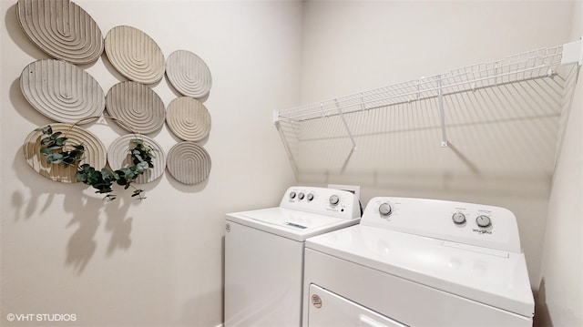 clothes washing area featuring separate washer and dryer