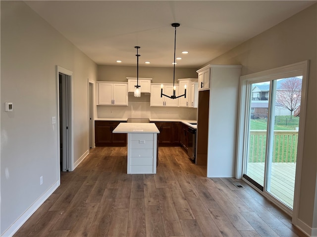 kitchen with white cabinets, dark wood-type flooring, and a center island