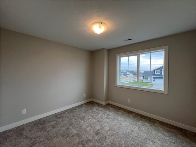 empty room featuring light colored carpet