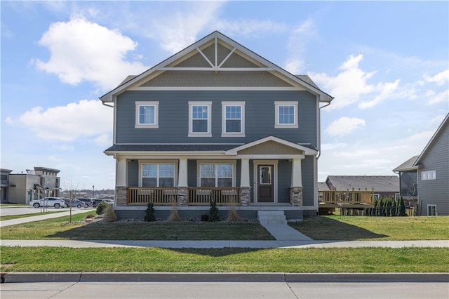 craftsman inspired home with covered porch and a front lawn