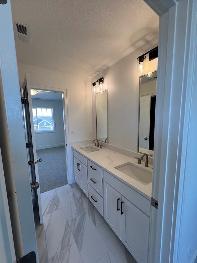 bathroom with vanity and a textured ceiling