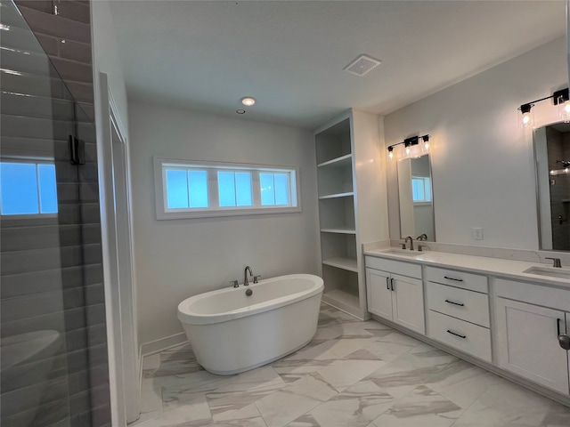 bathroom with vanity, independent shower and bath, and a wealth of natural light