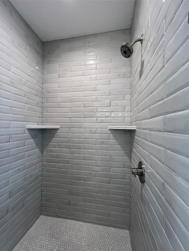 bathroom with a tile shower