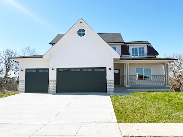 view of front of house with a garage and a front lawn