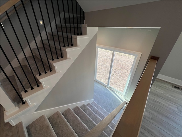 stairs featuring hardwood / wood-style flooring