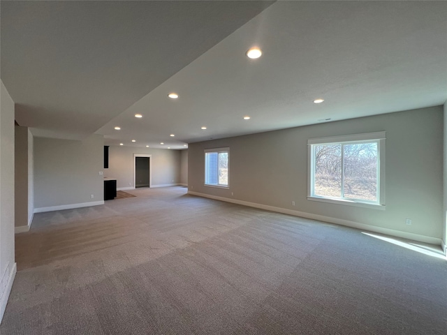 unfurnished living room featuring light colored carpet