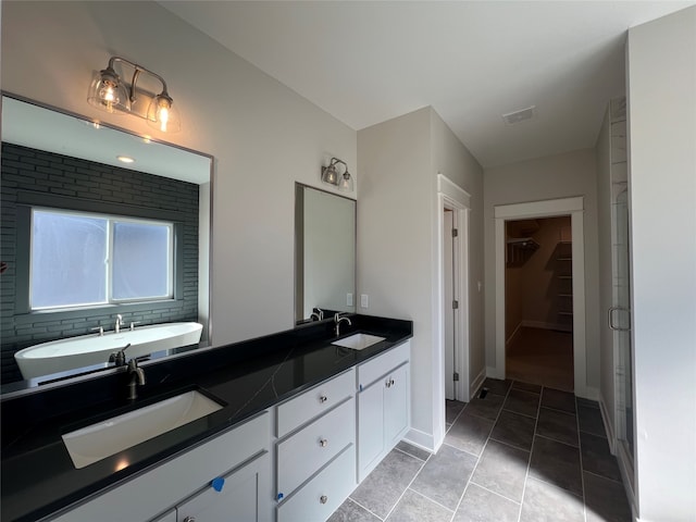 bathroom with independent shower and bath, vanity, and tile patterned floors