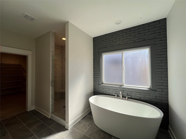 bathroom with tile patterned floors and separate shower and tub