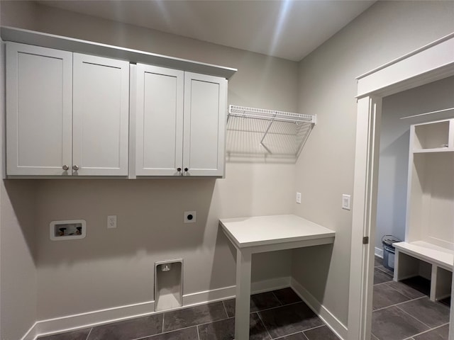 laundry area featuring cabinets, hookup for a washing machine, hookup for an electric dryer, and dark tile patterned floors