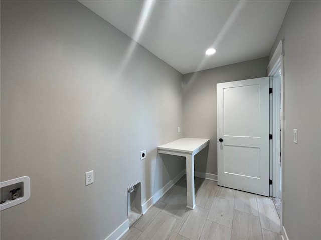 washroom with light hardwood / wood-style flooring, washer hookup, and hookup for an electric dryer