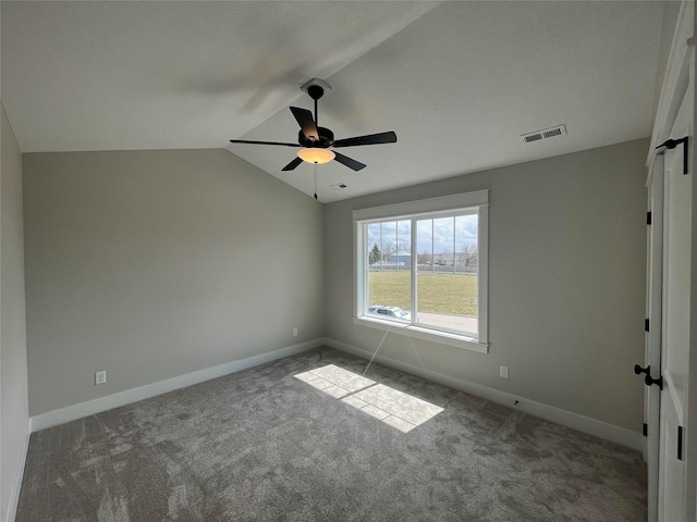 carpeted empty room with ceiling fan and lofted ceiling