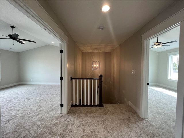 hallway with lofted ceiling and carpet floors