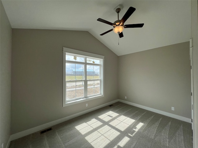 carpeted empty room with ceiling fan and vaulted ceiling