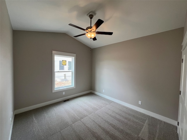 unfurnished room featuring light colored carpet, lofted ceiling, and ceiling fan