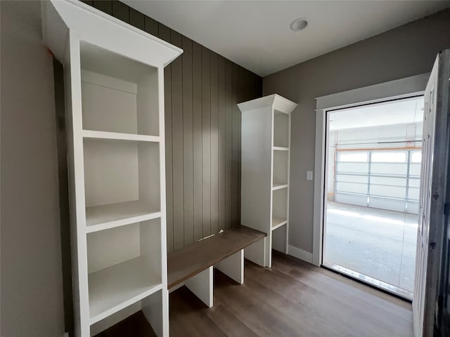 mudroom with wooden walls and hardwood / wood-style flooring