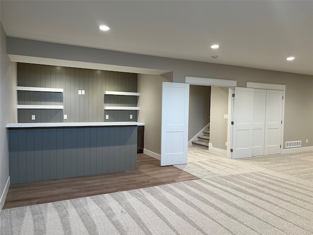 interior space featuring wood walls and light hardwood / wood-style floors