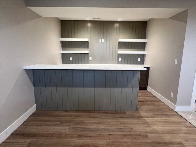 kitchen with kitchen peninsula and dark hardwood / wood-style floors