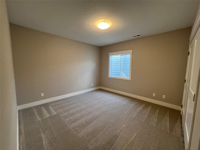 unfurnished bedroom with carpet and a textured ceiling