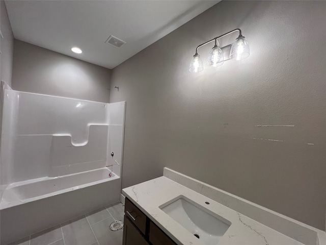 bathroom featuring vanity, tile patterned flooring, and shower / washtub combination