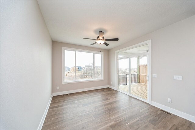 unfurnished room with light wood-type flooring and ceiling fan