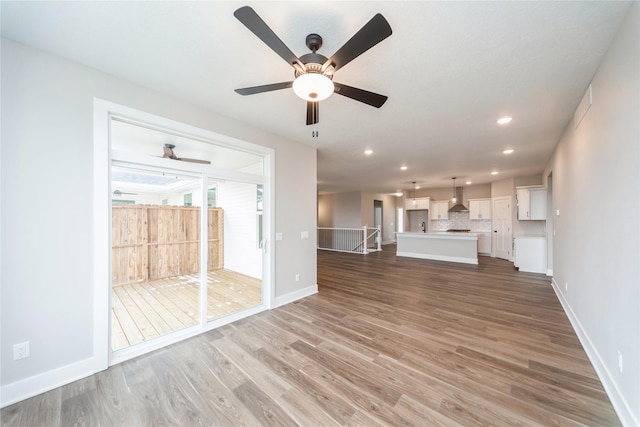 unfurnished living room featuring wood-type flooring