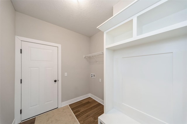 washroom featuring washer hookup, a textured ceiling, and dark hardwood / wood-style flooring