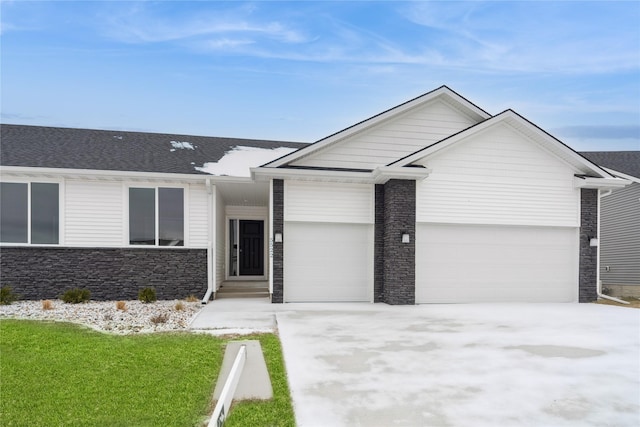 single story home with a garage and a front yard