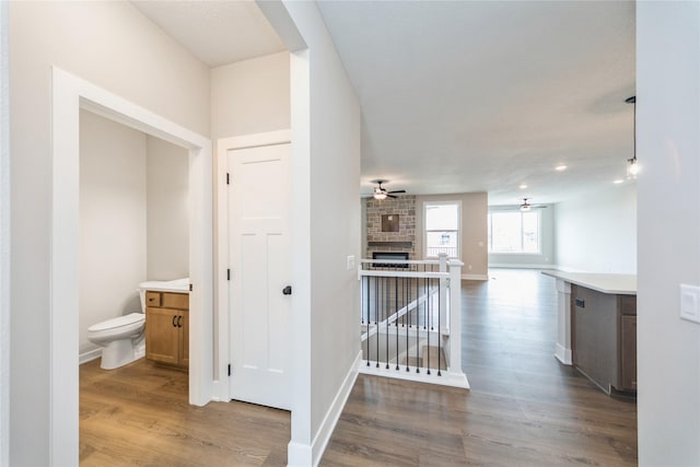 hallway with hardwood / wood-style floors