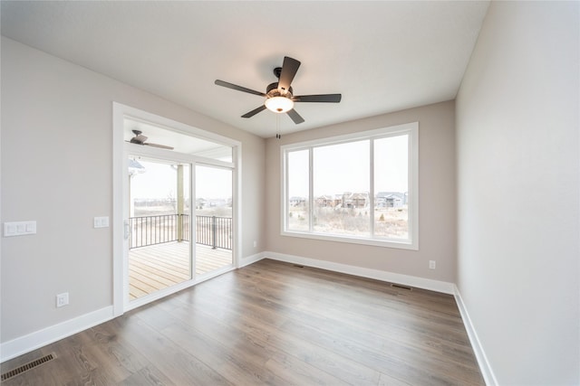 unfurnished room with hardwood / wood-style flooring and ceiling fan