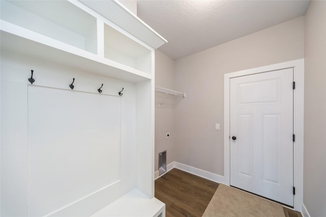 mudroom with a textured ceiling and dark hardwood / wood-style flooring