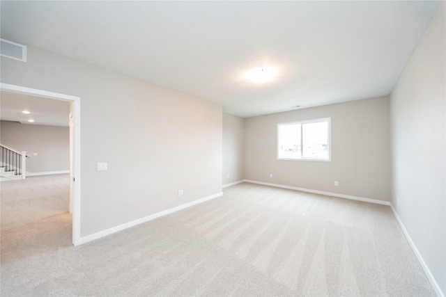 spare room with light carpet