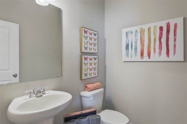 bathroom featuring sink and toilet