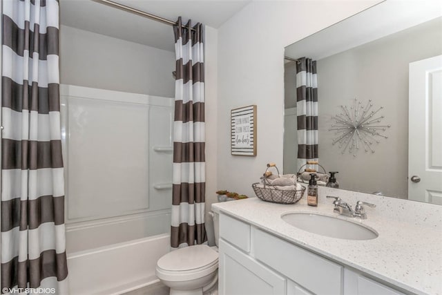 full bathroom with shower / bath combo with shower curtain, vanity with extensive cabinet space, and toilet