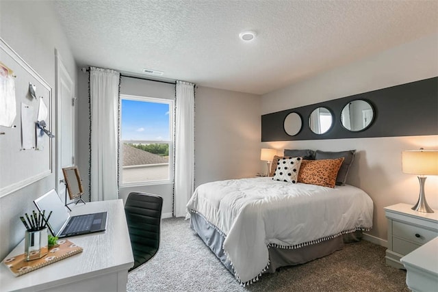 carpeted bedroom with a textured ceiling