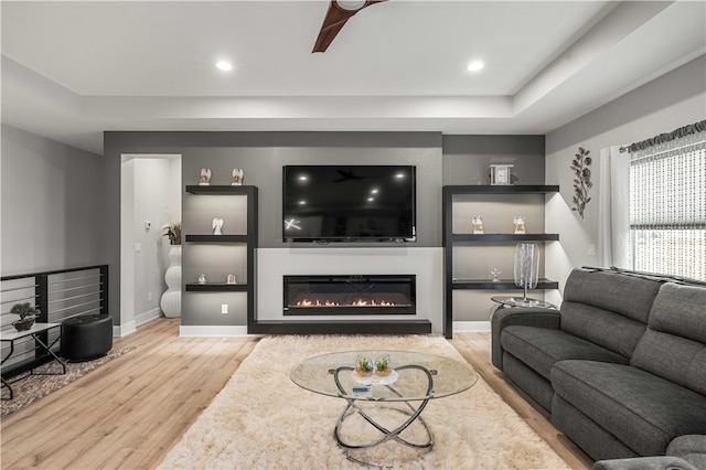 living room featuring ceiling fan and light wood-type flooring