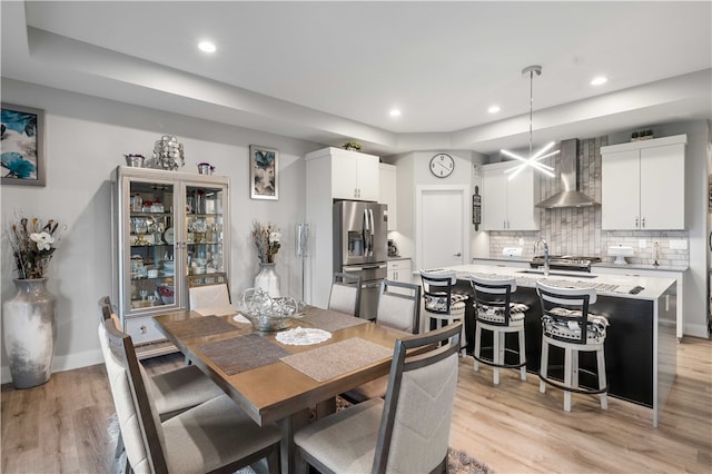 dining room with light hardwood / wood-style floors and sink