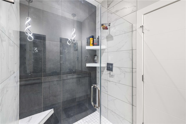 bathroom with a shower with door