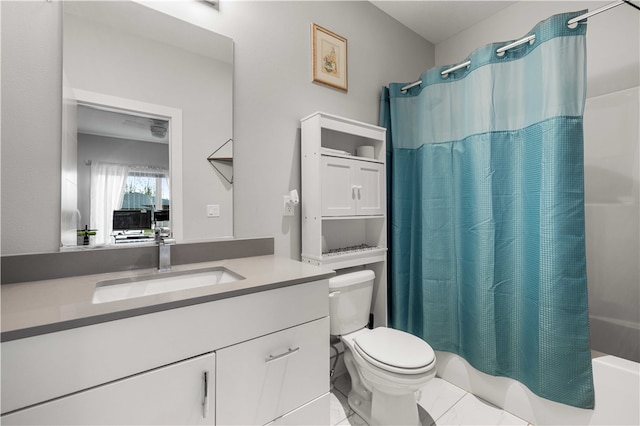 bathroom featuring toilet, tile flooring, and oversized vanity