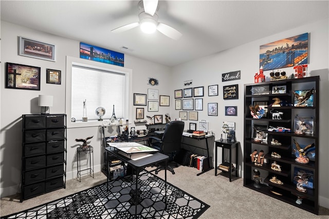 home office featuring light carpet and ceiling fan