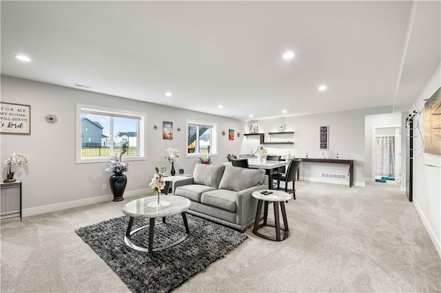 carpeted living room featuring a barn door