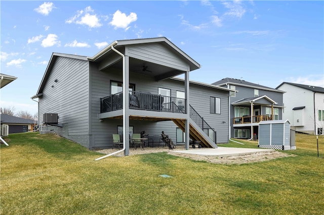 rear view of house with a yard and ceiling fan