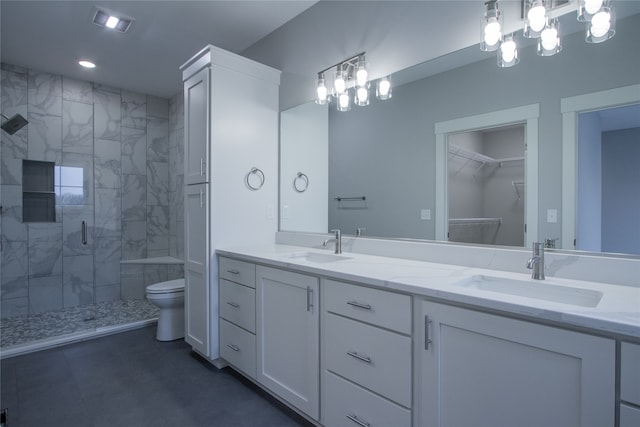 bathroom featuring vanity, toilet, and an enclosed shower