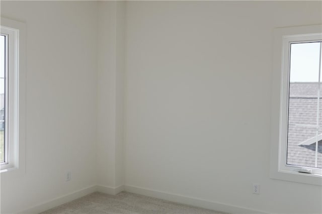 unfurnished room featuring carpet flooring