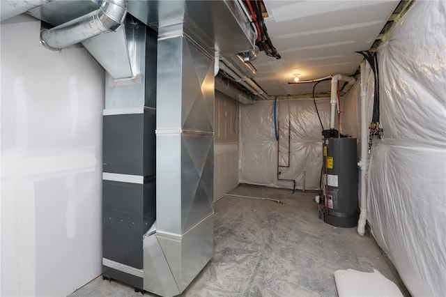 utility room featuring gas water heater and heating unit