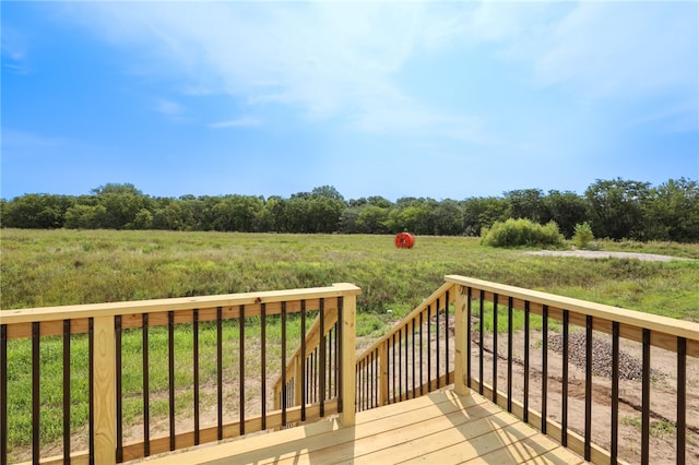 wooden deck with a rural view