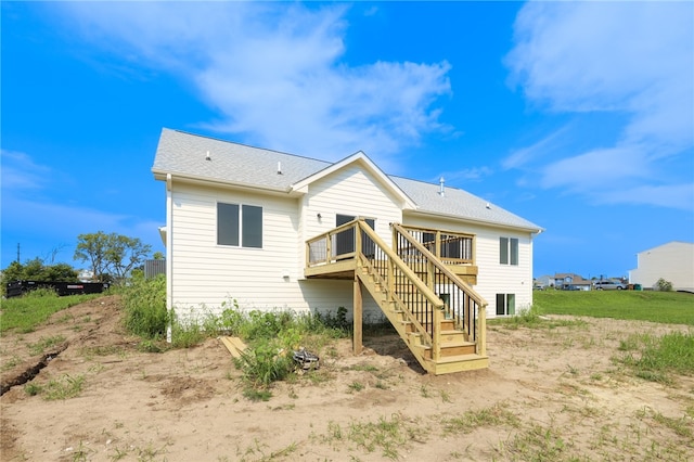 back of house with a deck