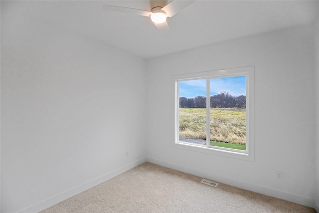 empty room with ceiling fan and carpet floors