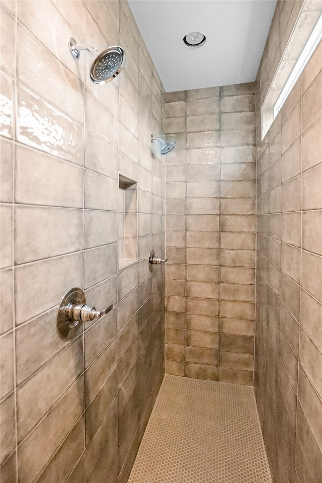 bathroom with a tile shower