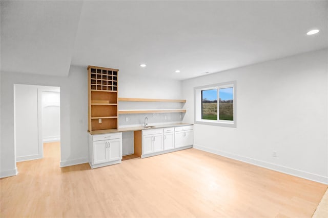 1772 Highland Cir SW, Altoona, IA 50009 - bar area with a sink, light wood finished floors, backsplash, recessed lighting, and baseboards