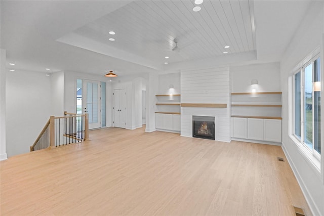 1772 Highland Cir SW, Altoona, IA 50009 - unfurnished living room featuring plenty of natural light, light wood-style floors, a tray ceiling, recessed lighting, and wood ceiling
